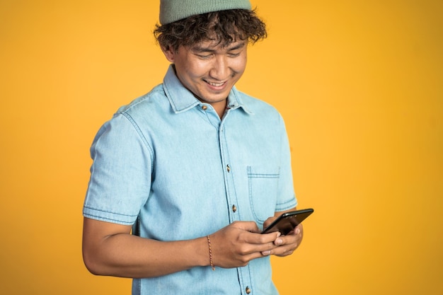 Asian young man looking at the screen of a mobile phone