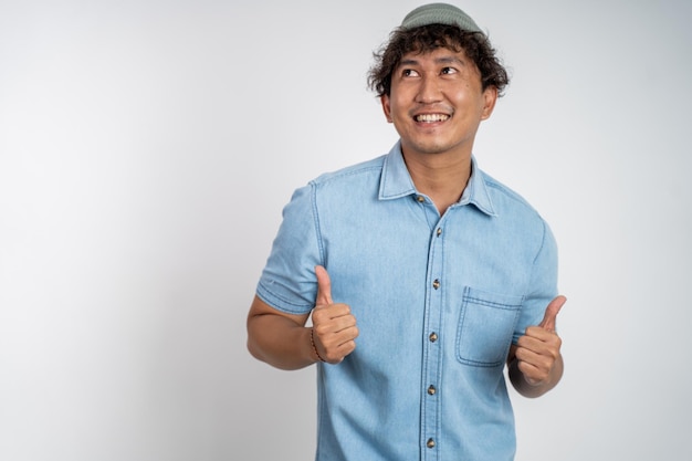 Asian young man showing thumbs up with smiling teeth