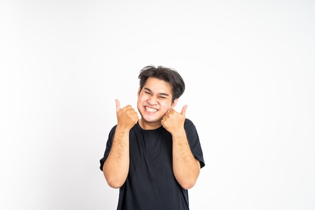 Asian young man showing thumbs up with smiling teeth