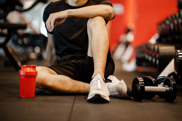 Asian young man sitting rest after workout for good healthy in fitness Lifestyle and sport exercise concept