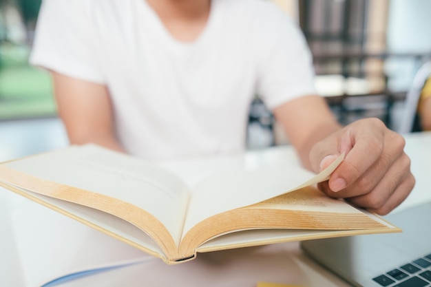 Asian young man studying and reading at home preparing for exams