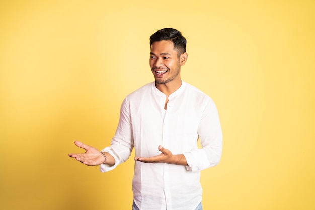 Asian young man with both hands presenting something