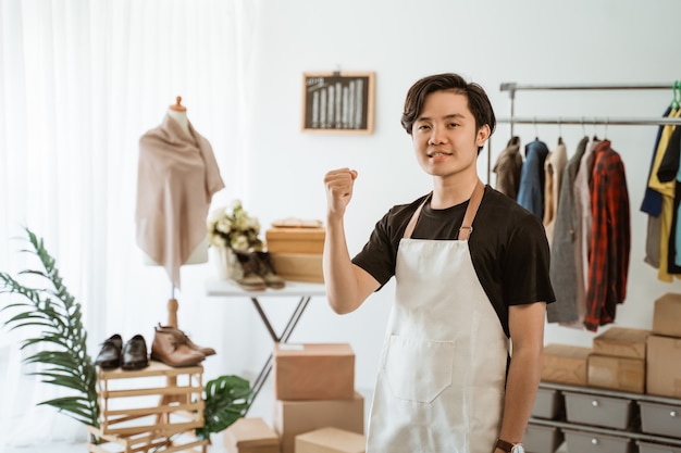 Asian young man working in a clothing store