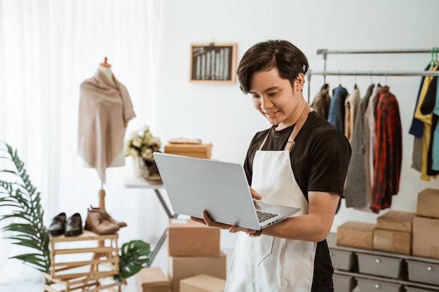 Asian young man working in a clothing store