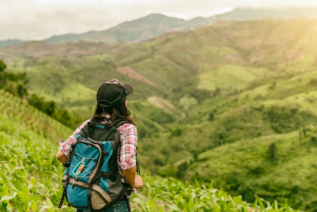 Asian young woman backpack travel enjoy with sky background in nature rice farm.