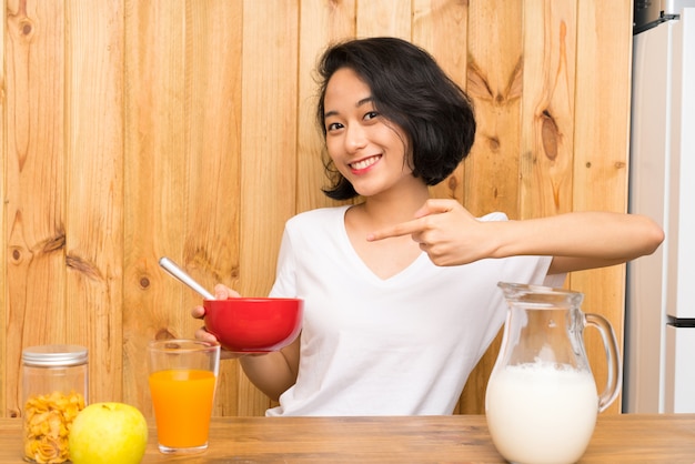 Asian young woman having breakfast