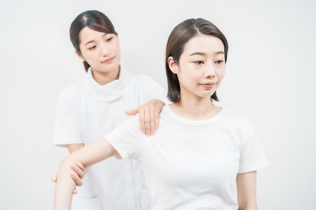 Asian young woman receiving a massage at an esthetic salon