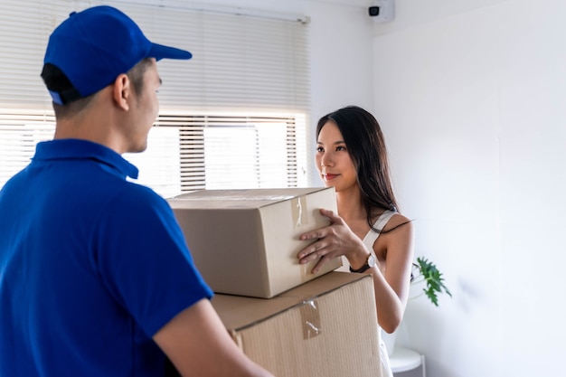 Asian young woman receiving package from delivery man