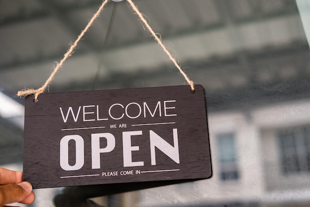 Asians with sign open and closed in restaurant for lockdown ideas unlock freedom tourist travel