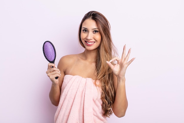 Asiatic pretty woman feeling happy, showing approval with okay gesture. hair care concept