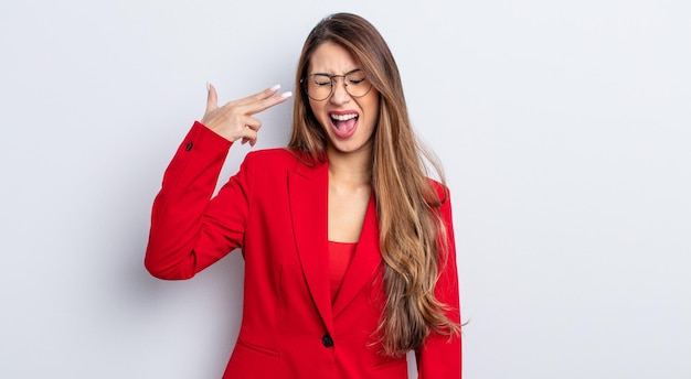 Asiatic pretty woman looking unhappy and stressed, suicide gesture making gun sign. business concept