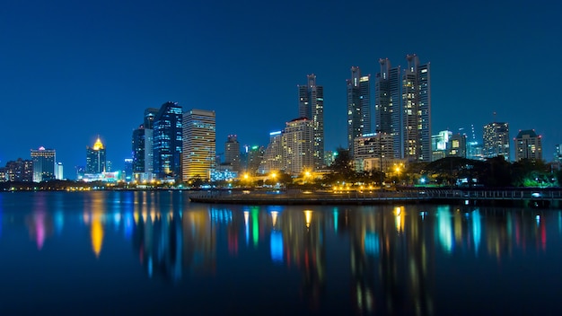 Asoke modern buildings of Bangkok night city skyline, Thailand.