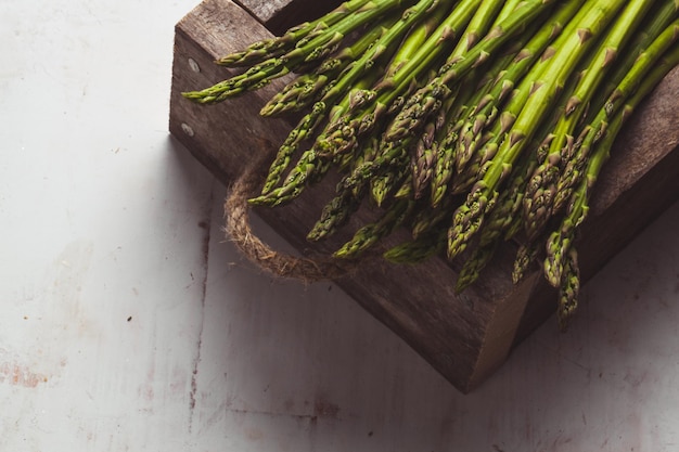 Asparagus on a cutting board. Healthy food, health on a concrete background.