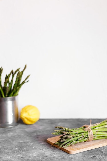 Asparagus. Fresh green asparagus on grey rustic background. Top view copy space. Bunches of green asparagus