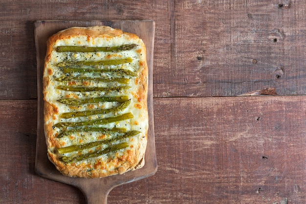 Asparagus green pizza with herbs and mozzarella background