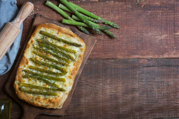 Asparagus green pizza with herbs and mozzarella background