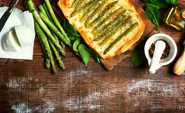 Asparagus green pizza with herbs and mozzarella background