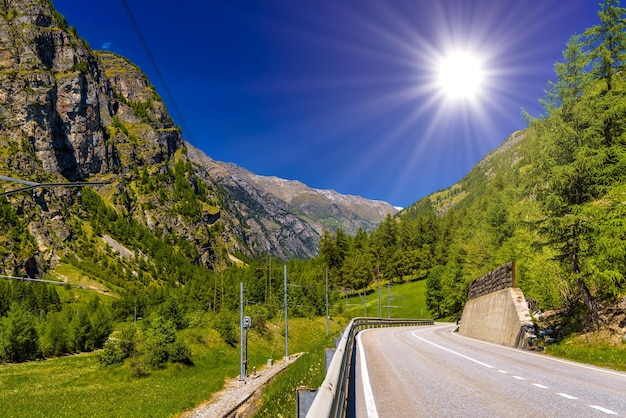 Asphalt road in Alps mountains Randa Visp Wallis Valais Swi