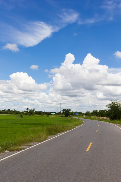 Asphalt road and clouds on blue sky