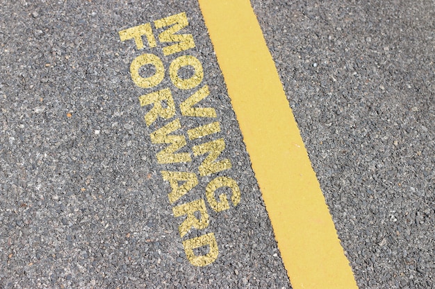 The asphalt road has a yellow stripe, Inspiration typographic quotes.