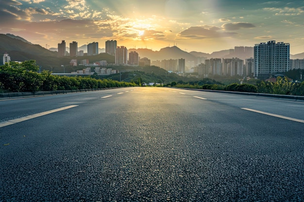 Asphalt road and mountain with city skyline scenery