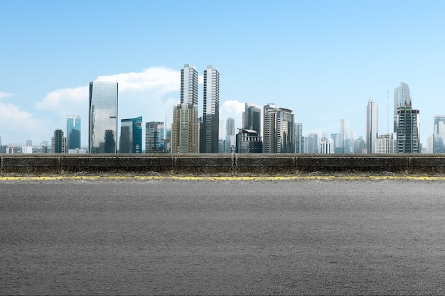 Asphalt road with modern building and skyscrapers on the midtown