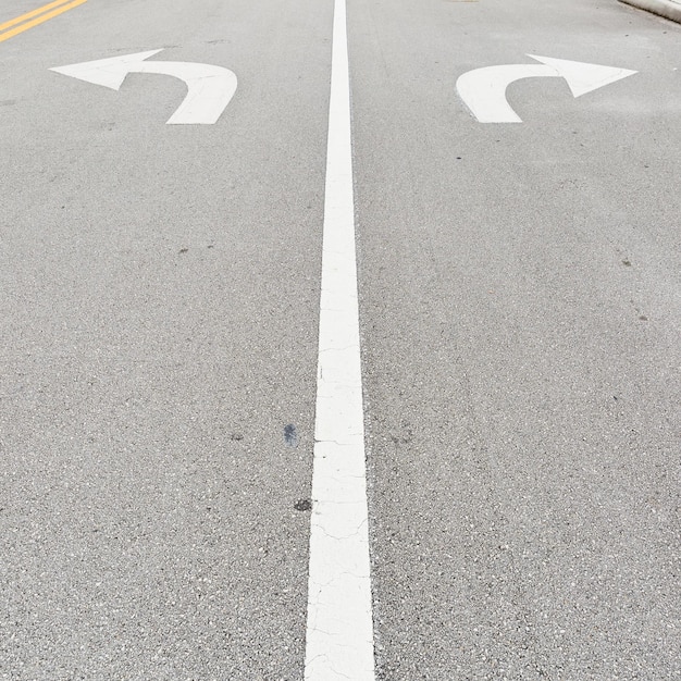 Asphalt road with road signs for turns