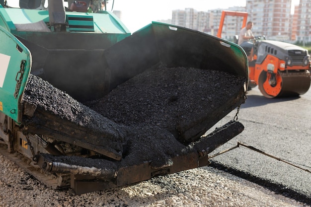 An asphalt spreader or an asphalt paver machine on a road construction site Road repairs