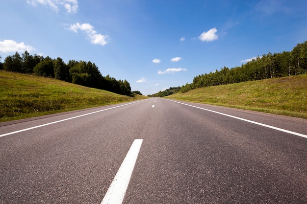 The asphalted road - the small rural asphalted road photographed in summertime of year. 