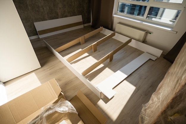 assembly of a double bed made of wood and lamella