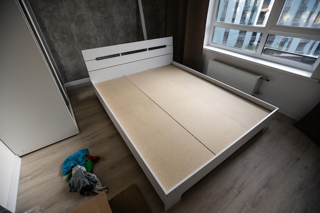 assembly of a double bed made of wood and lamella