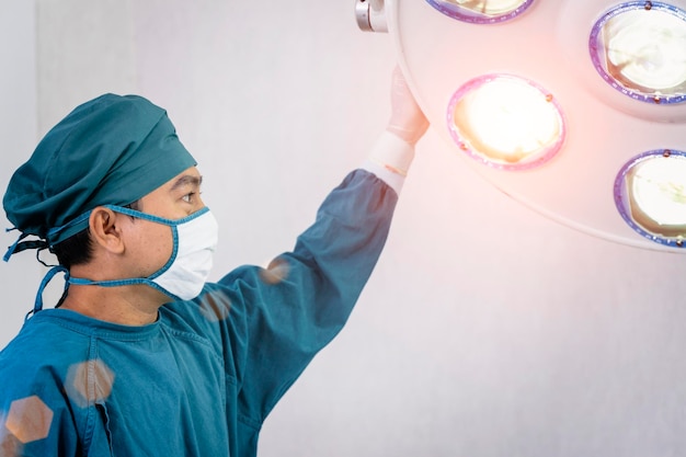 Assistant surgeon preparing surgical lamps in the operating room