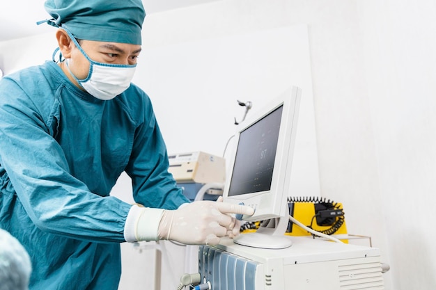 Assistant surgeon put the patient on a ventilatoroxygen mask in preparation for surgery