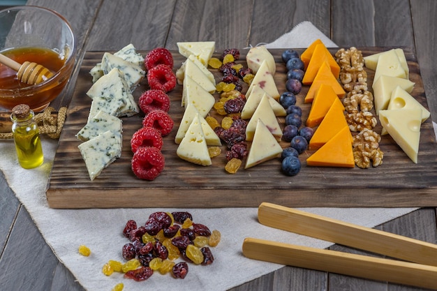 assorted cheese board with honey and nuts