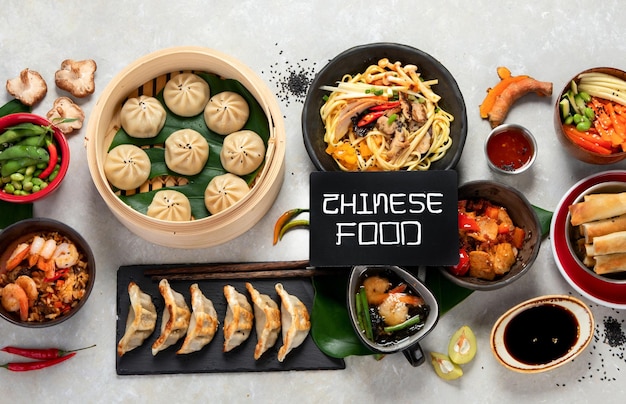 Assorted Chinese food on dark background Chinese cuisine dishes on table Asian food concept Top view