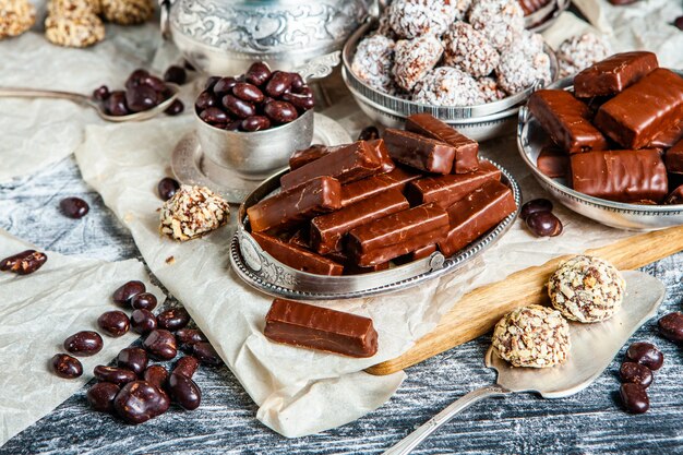 Assorted chocolate candies on wooden background