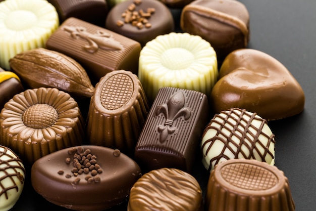 Assorted chocolates on a black background.