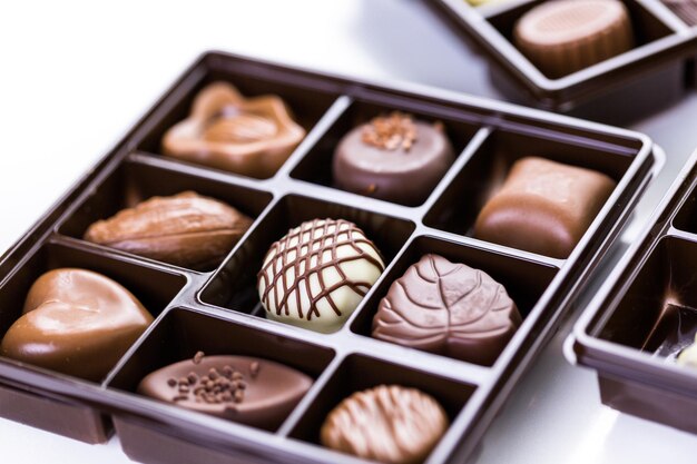 Assorted chocolates in box on a white background.