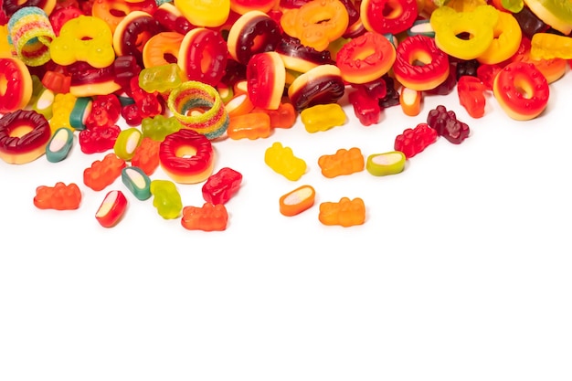 Assorted colorful gummy candies Top view Jelly donuts Jelly bears Isolated on a white background