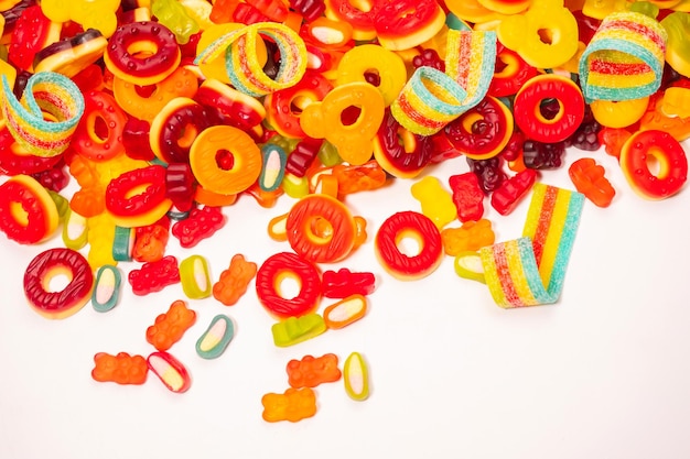 Assorted colorful gummy candies Top view Jelly donuts Jelly bears Isolated on a white background