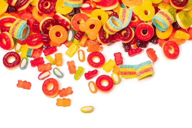 Assorted colorful gummy candies Top view Jelly donuts Jelly bears Isolated on a white background