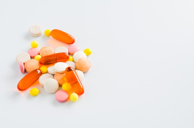 Assorted colorful tablets, pills, drugs on white background