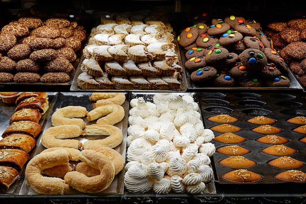 Assorted cookies, cakes and sweet treats on display of a cafe or bakery