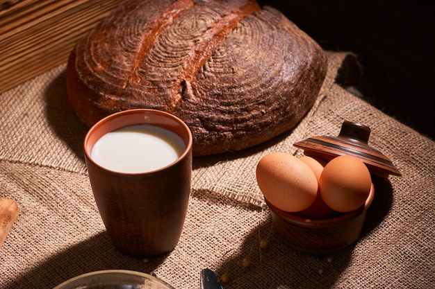 Assorted dairy products milk, cheese, eggs, rustic still life