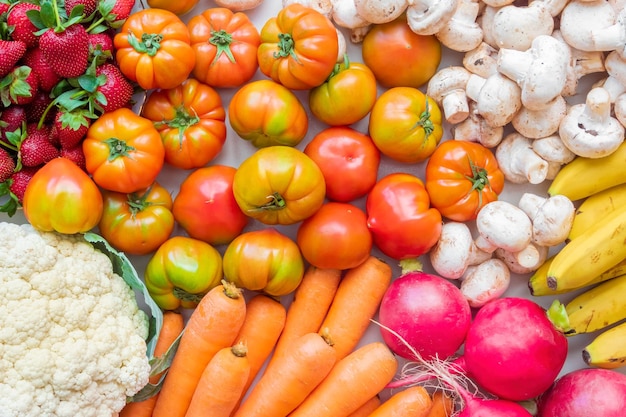 Assorted fresh ripe vegetables and fruits healthy food concept background top view