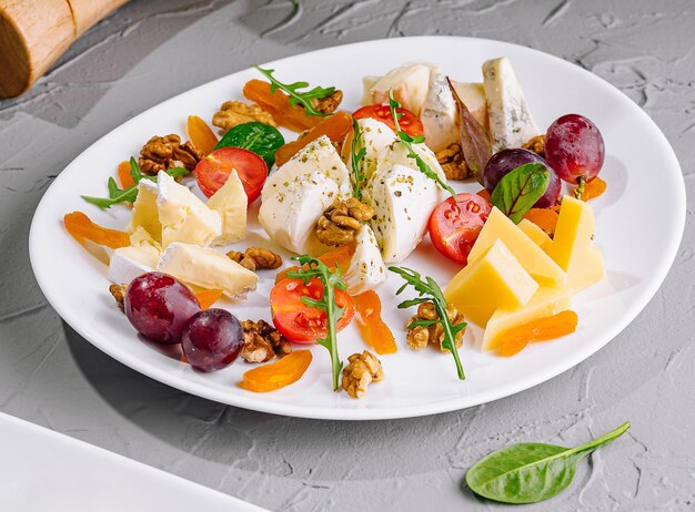 Assorted fruit and cheese plateCloseup of delicious food plate