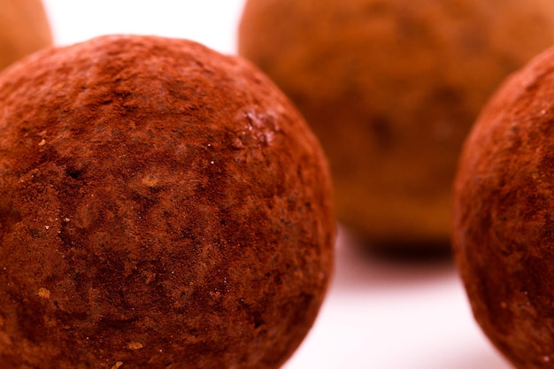 Photo assorted gourmet truffles on a white background.