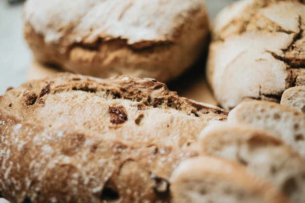 Assorted homemade bread on white clean wood backgroundFresh tasty breadBakery rustic crusty loaves of bread and bunsHomemade natural breads Different kinds of fresh bread as background