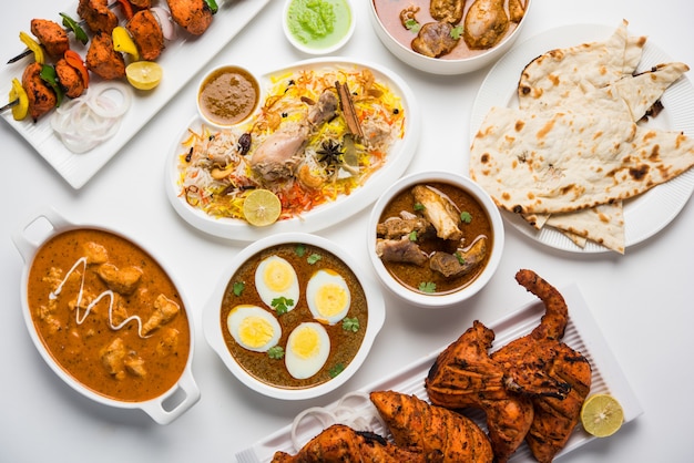 Assorted Indian Non Vegetarian food recipe served in a group. Includes Chicken Curry, Mutton Masala, Anda or egg curry, Butter chicken, biryani, tandoori murg, chicken-tikka and naa, roti for ramadan