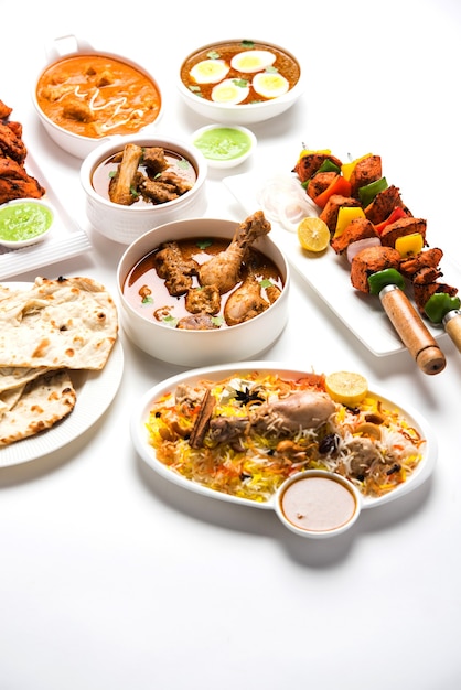 Assorted Indian Non Vegetarian food recipe served in a group. Includes Chicken Curry, Mutton Masala, Anda or egg curry, Butter chicken, biryani, tandoori murg, chicken-tikka and naa, roti for ramadan